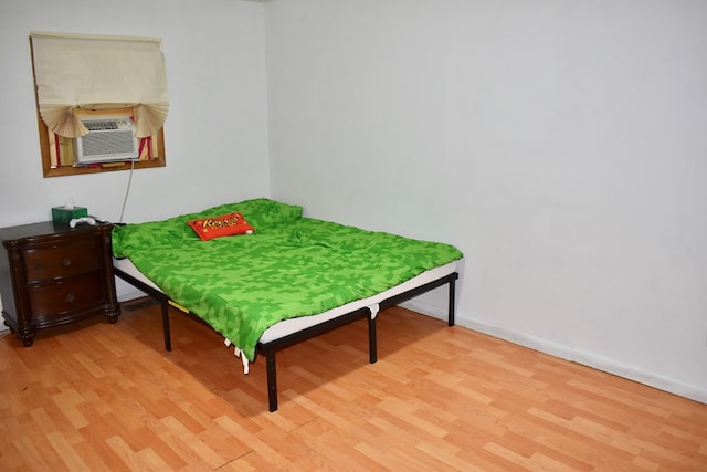 bedroom featuring cooling unit and light wood-type flooring