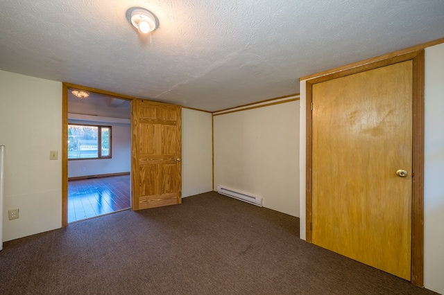 unfurnished bedroom with dark colored carpet, a closet, a textured ceiling, and a baseboard radiator