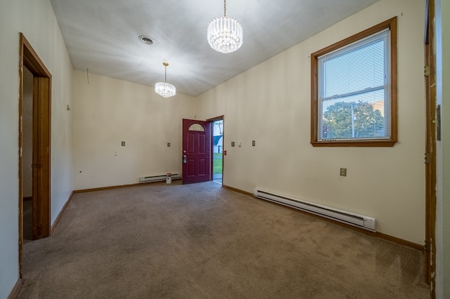 unfurnished room featuring baseboard heating, carpet floors, a healthy amount of sunlight, and a notable chandelier