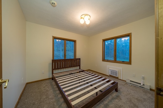 bedroom with carpet, an AC wall unit, and a baseboard heating unit