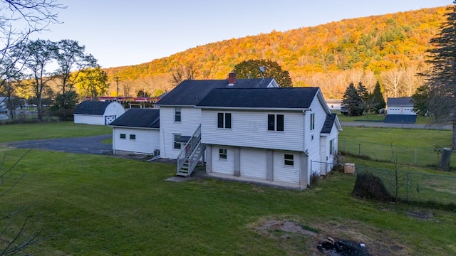 back of house featuring a lawn