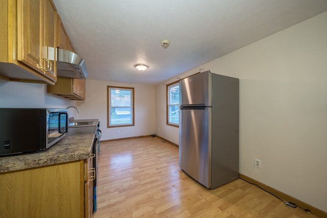 kitchen with ventilation hood, black electric range, stainless steel fridge, a textured ceiling, and light hardwood / wood-style floors