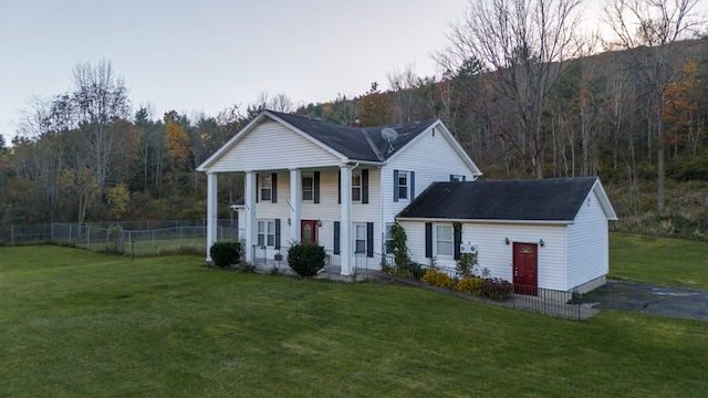 greek revival house with a yard and covered porch