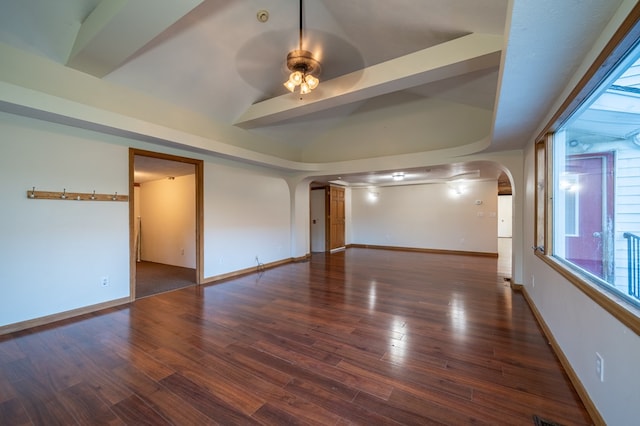 spare room featuring ceiling fan, dark hardwood / wood-style flooring, and vaulted ceiling