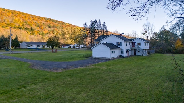 view of home's exterior featuring a mountain view and a yard