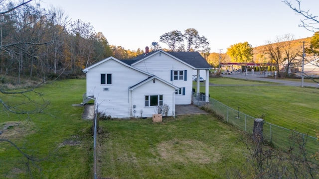 rear view of property featuring a yard