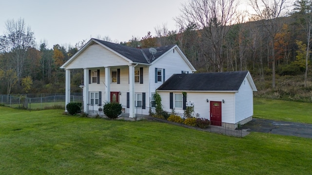 view of front of property with a lawn and a porch