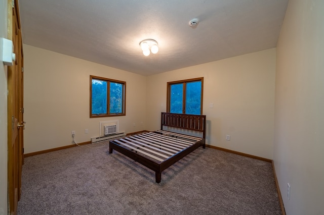 carpeted bedroom featuring a baseboard radiator