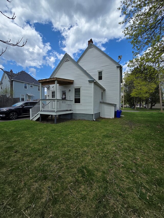 97 Lincoln St, Sayre, PA 18840 - rear view of house featuring a chimney, a yard, and a wooden deck