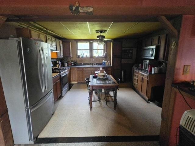 79 Back St, Millerton, PA 16936 - kitchen with appliances with stainless steel finishes, light flooring, extractor fan, ceiling fan, and dark countertops