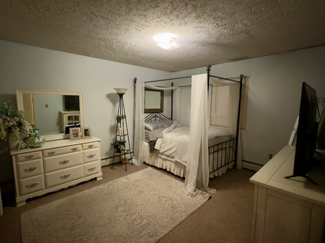 carpeted bedroom with a textured ceiling and a baseboard radiator