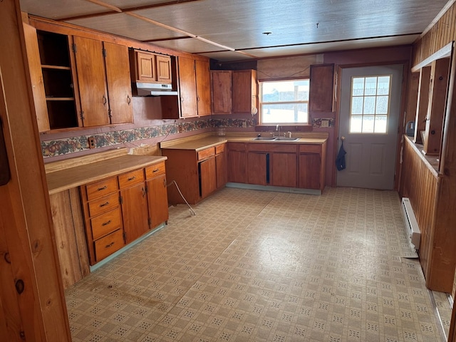 116 Morral Rd, Wellsboro, PA 16901 - kitchen with brown cabinets, under cabinet range hood, light floors, and baseboard heating