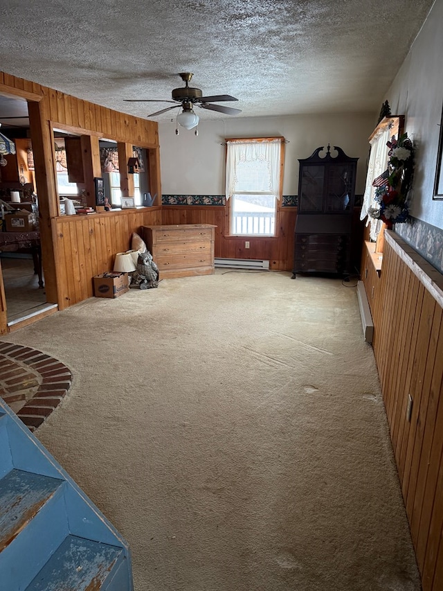 116 Morral Rd, Wellsboro, PA 16901 - living room with a textured ceiling, light colored carpet, ceiling fan, and wooden walls