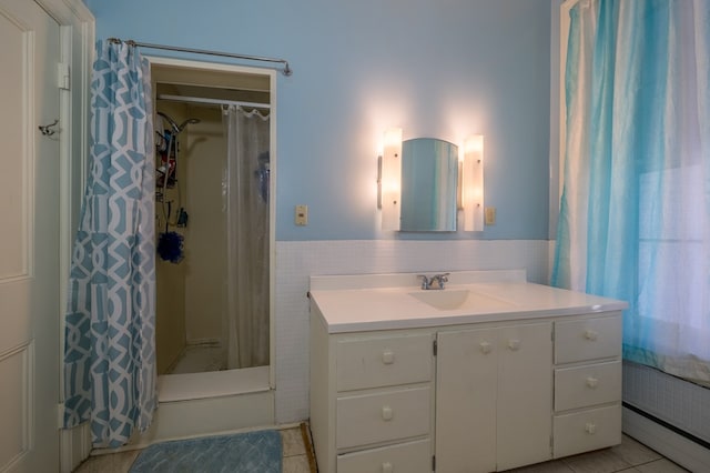 105 Chemung St, Waverly, NY 14892 - bathroom with tile walls, wainscoting, vanity, tile patterned floors, and a baseboard heating unit