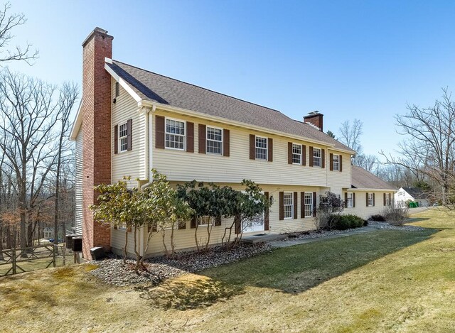 view of front of property with a front lawn, fence, and a chimney