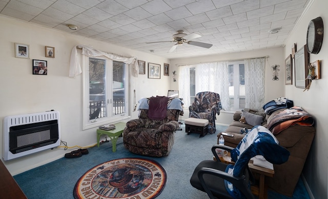 carpeted living room featuring a ceiling fan and heating unit