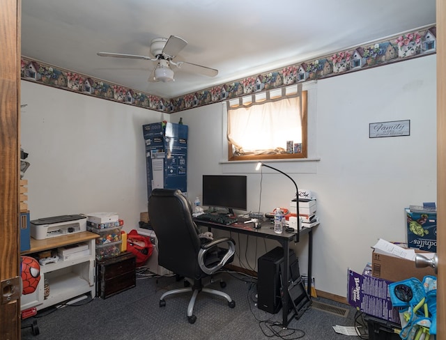 carpeted home office featuring baseboards and a ceiling fan