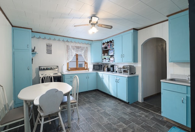 kitchen with blue cabinetry, white electric stove, and light countertops