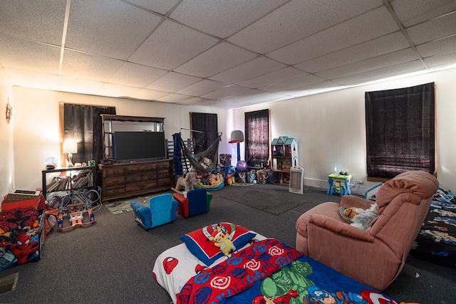 carpeted living room with a drop ceiling