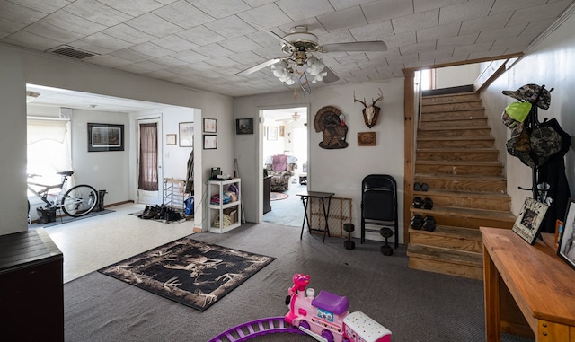 interior space featuring stairs, ceiling fan, and visible vents