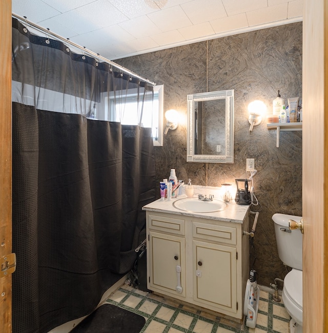 bathroom with toilet, a shower with shower curtain, vanity, tile patterned floors, and wallpapered walls