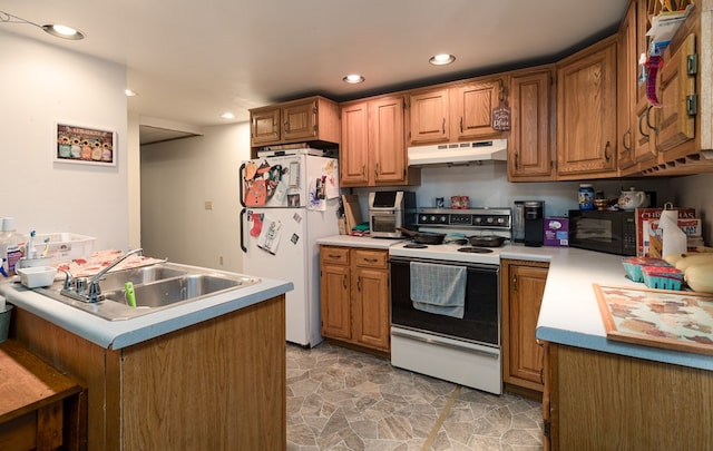 kitchen featuring brown cabinets, white appliances, under cabinet range hood, and light countertops