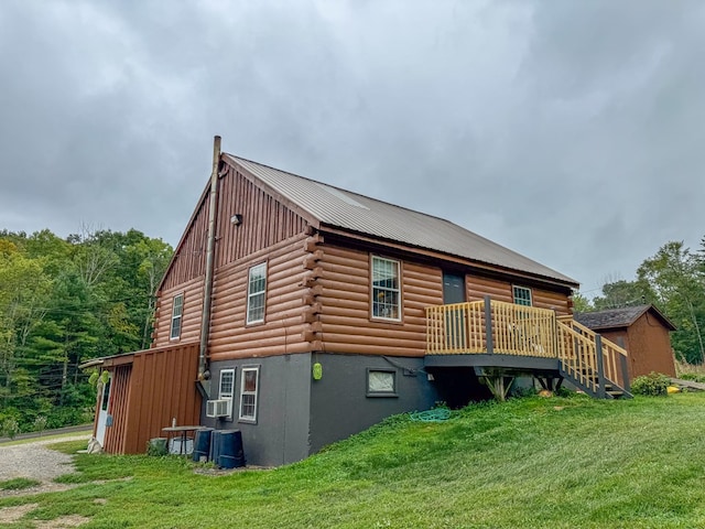 rear view of house featuring a yard