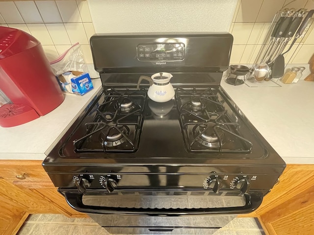 16 Quarry Ln, Galeton, PA 16922 - interior details with light countertops, gas stove, and tasteful backsplash