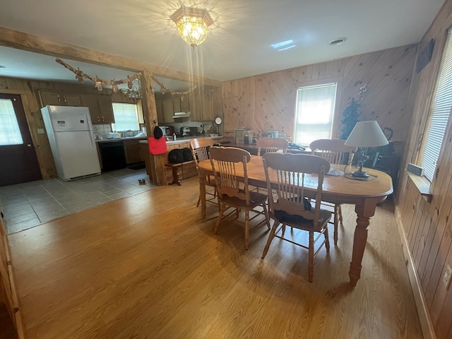 16 Quarry Ln, Galeton, PA 16922 - dining room featuring visible vents, wood walls, and light wood-style flooring