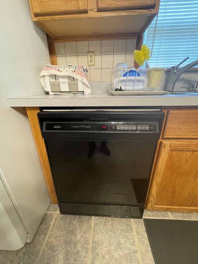 16 Quarry Ln, Galeton, PA 16922 - room details with light countertops, backsplash, black dishwasher, and brown cabinetry