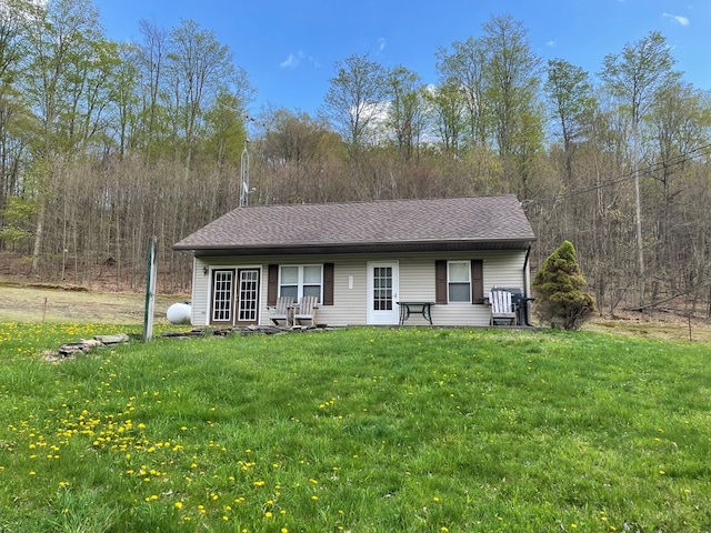 16 Quarry Ln, Galeton, PA 16922 - view of front facade with a view of trees, a shingled roof, and a front yard