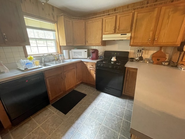 16 Quarry Ln, Galeton, PA 16922 - kitchen featuring under cabinet range hood, backsplash, a sink, and black appliances