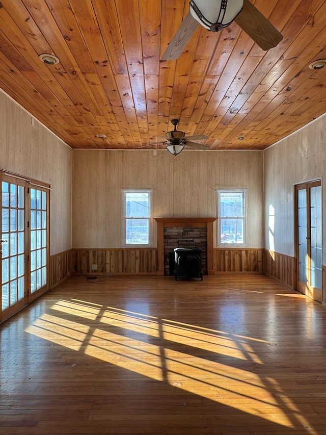 unfurnished living room featuring a healthy amount of sunlight, french doors, and wooden ceiling