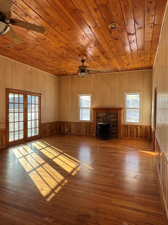 unfurnished living room with wooden ceiling, hardwood / wood-style floors, and plenty of natural light