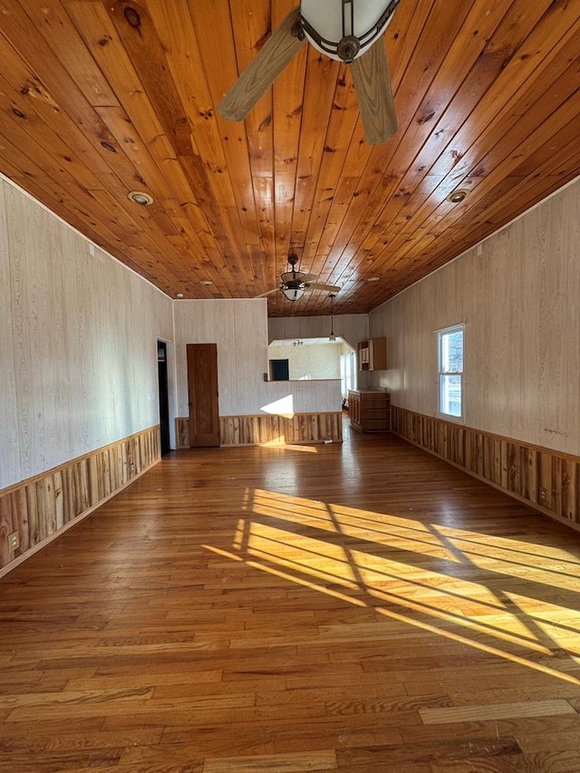 interior space with ceiling fan, wood ceiling, and hardwood / wood-style floors