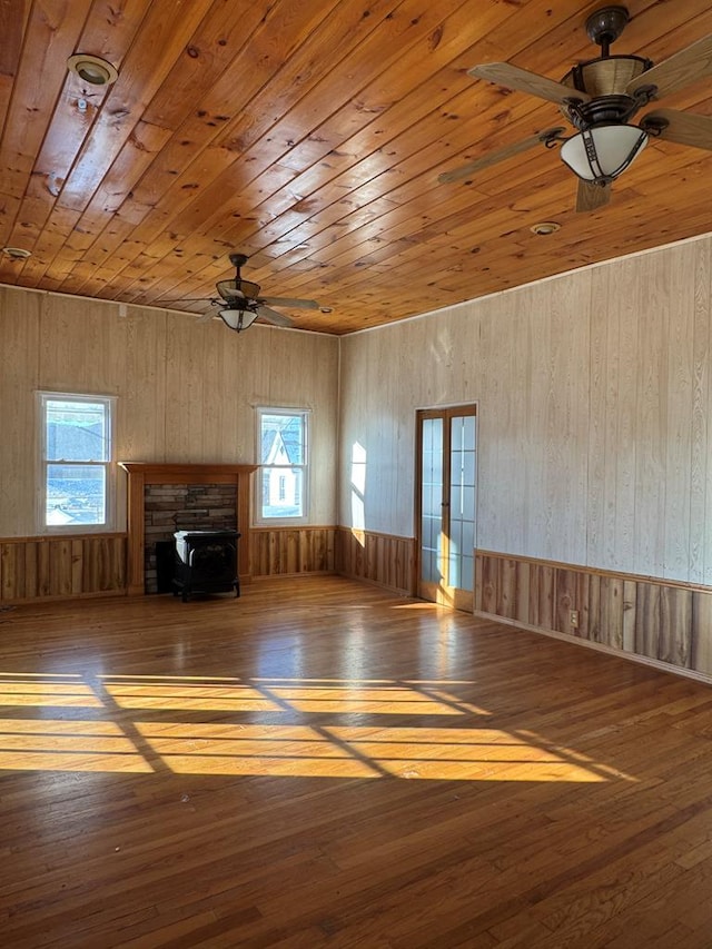 unfurnished living room featuring hardwood / wood-style flooring, wooden ceiling, and ceiling fan