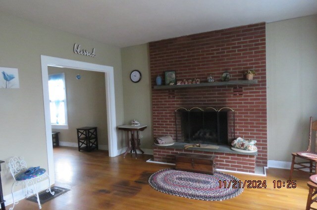 living room featuring a fireplace and hardwood / wood-style flooring