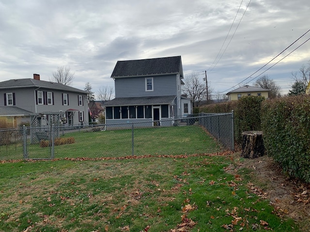 rear view of property featuring a yard