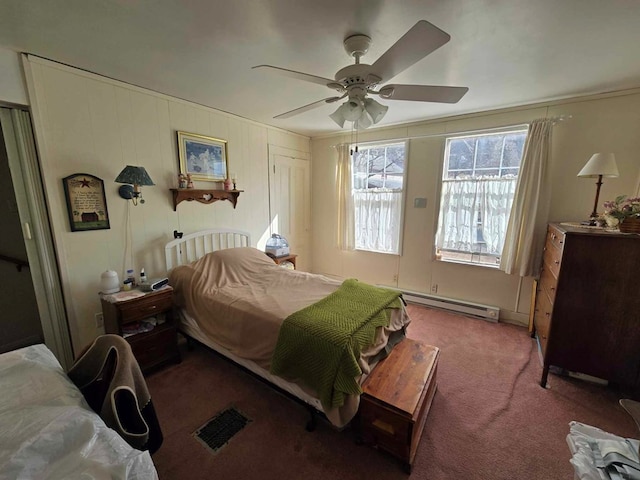 bedroom featuring carpet flooring, visible vents, baseboard heating, and ceiling fan