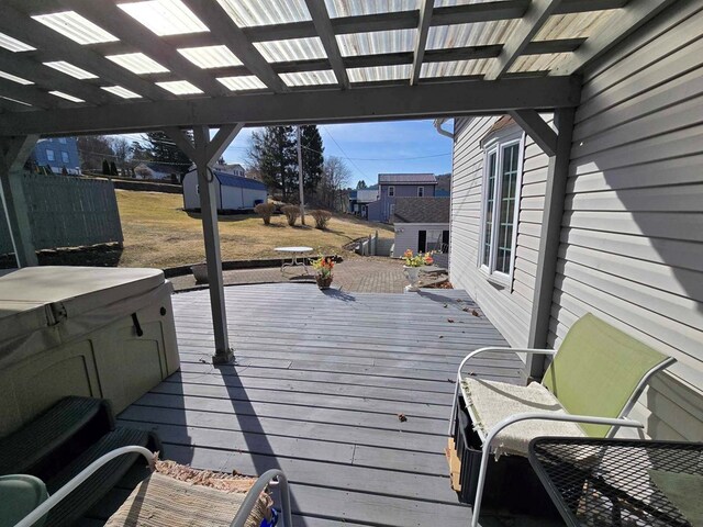 deck featuring an outbuilding and a hot tub