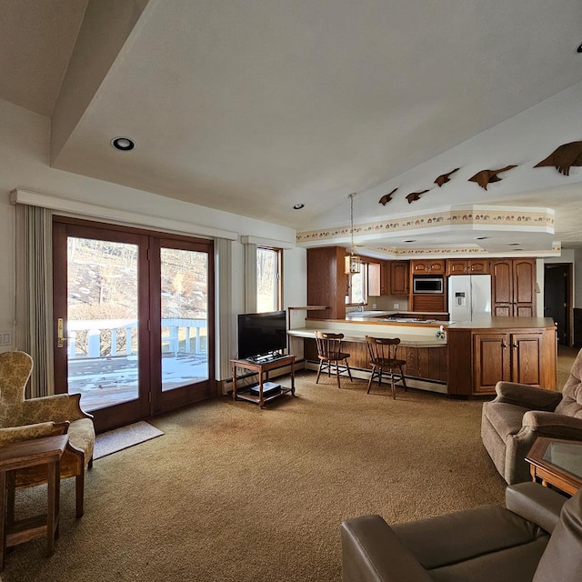 living room with baseboard heating, light colored carpet, and lofted ceiling