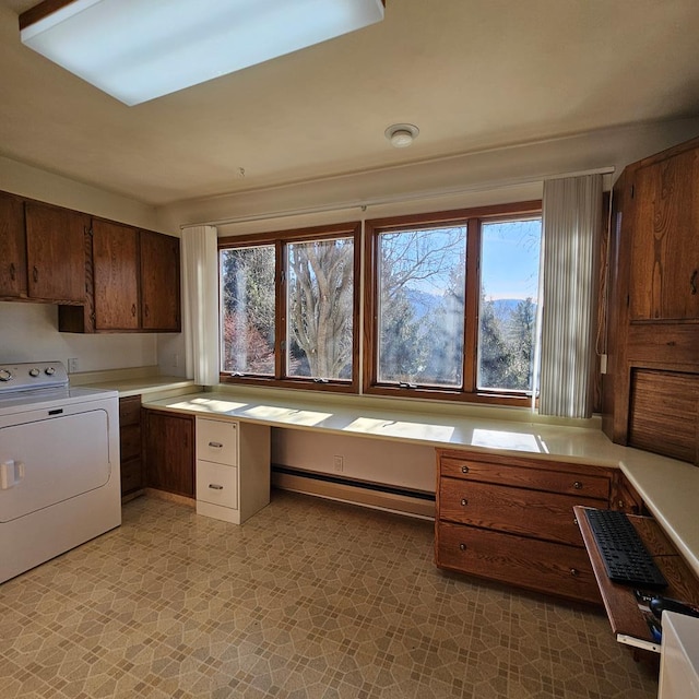 interior space featuring washer / clothes dryer, a baseboard radiator, and a healthy amount of sunlight