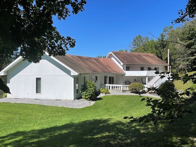 rear view of house with a lawn