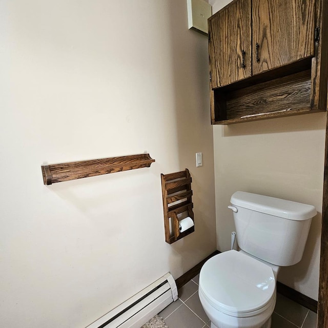 bathroom with tile patterned flooring, a baseboard heating unit, and toilet