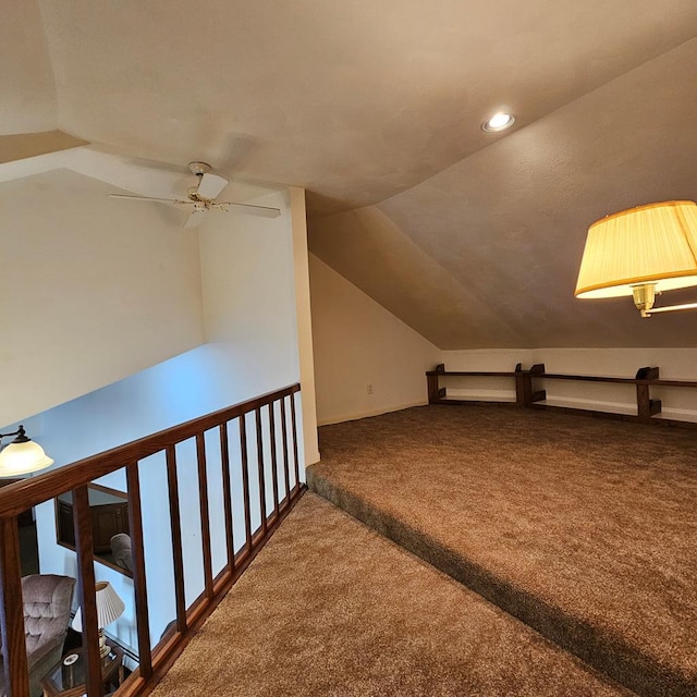 additional living space with vaulted ceiling, ceiling fan, and carpet flooring