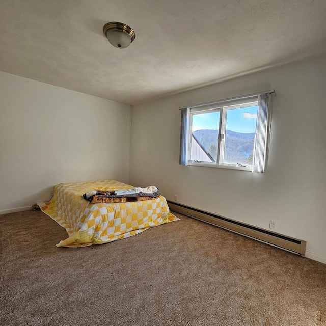 unfurnished bedroom featuring a baseboard heating unit and carpet flooring