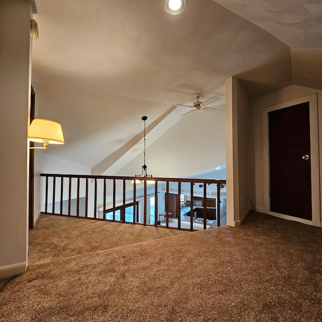 hall featuring lofted ceiling and carpet