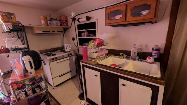 kitchen with white range with gas stovetop and sink