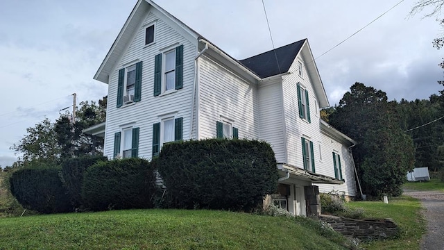 view of home's exterior with a yard