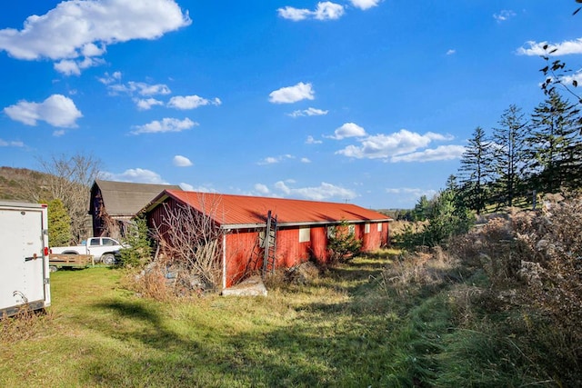 view of outbuilding with a lawn